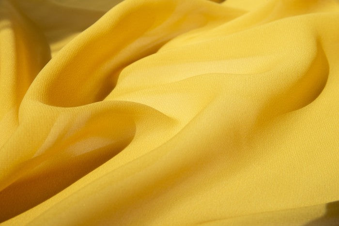 Detail van de zachte gele Playcycle speeldoek
